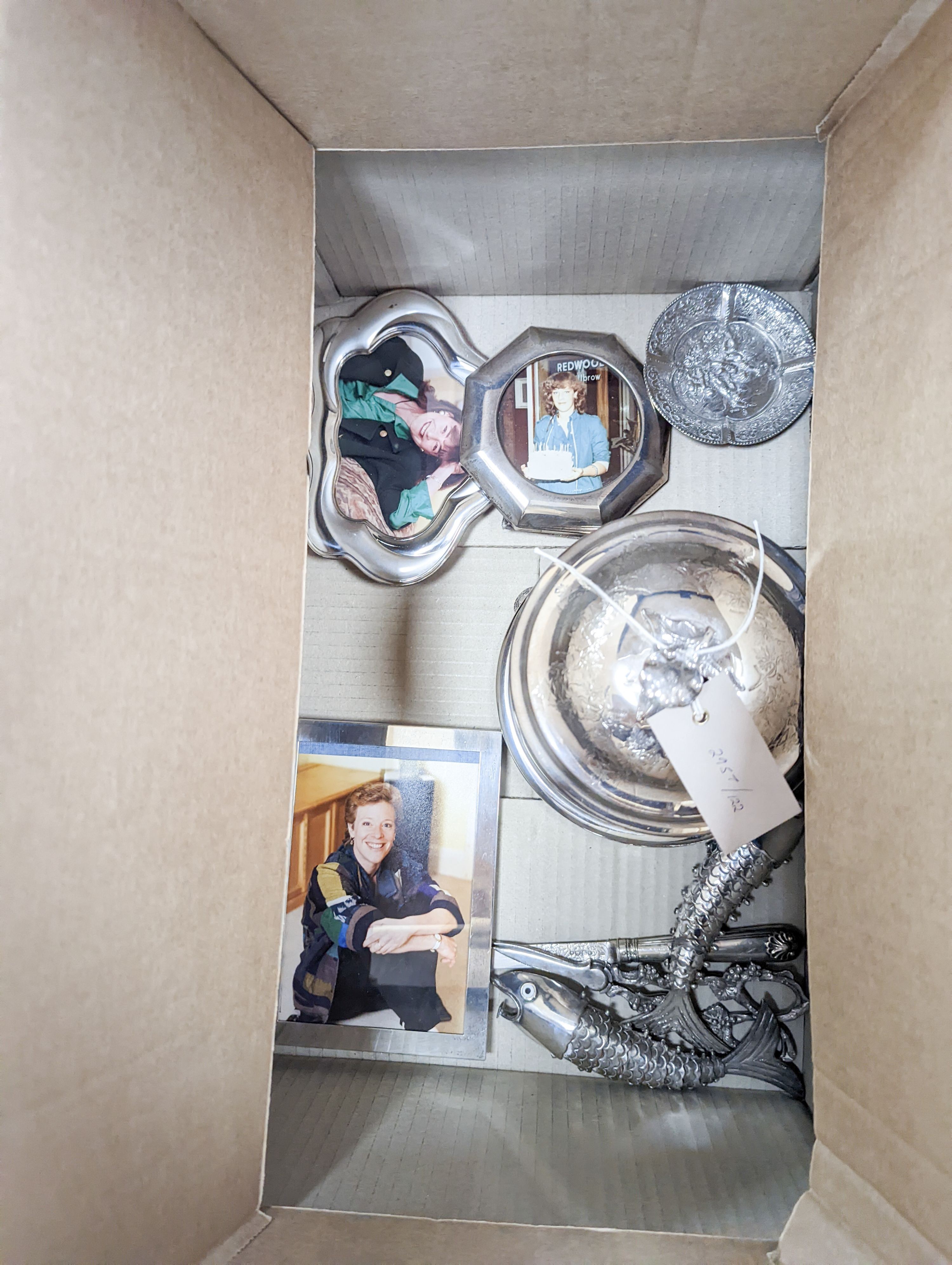 A pair of plated articulated fish, 3 plated photo frames, glassware etc